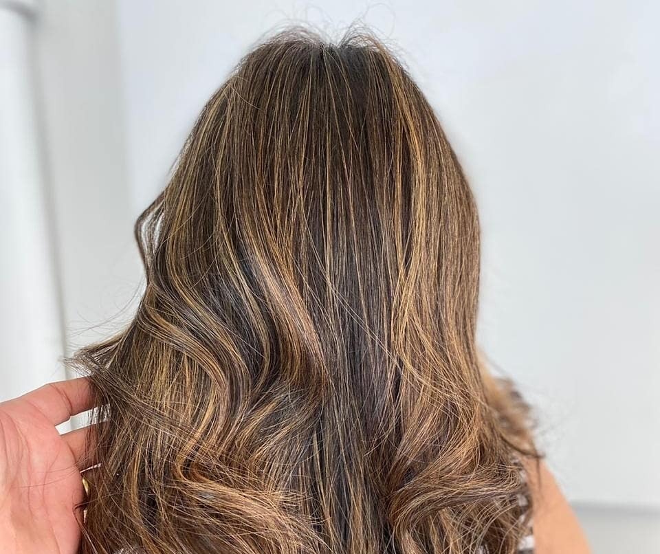 Balayage em cabelo castanho ondulado