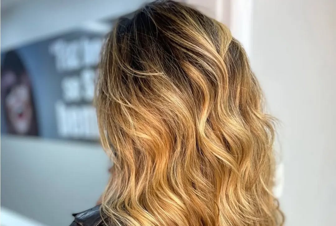 Balayage dourado em cabelo ondulado